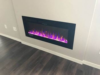 An electric fireplace in a room with a wooden floor